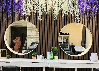 Stylish vanity with round mirrors at Shriji Beauty Touch, Huddersfield, England, GB.