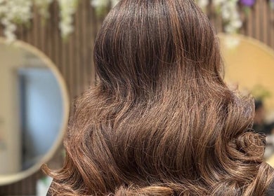 Luscious brown hair styled in elegant waves at Shriji Beauty touch, Huddersfield, England, GB.