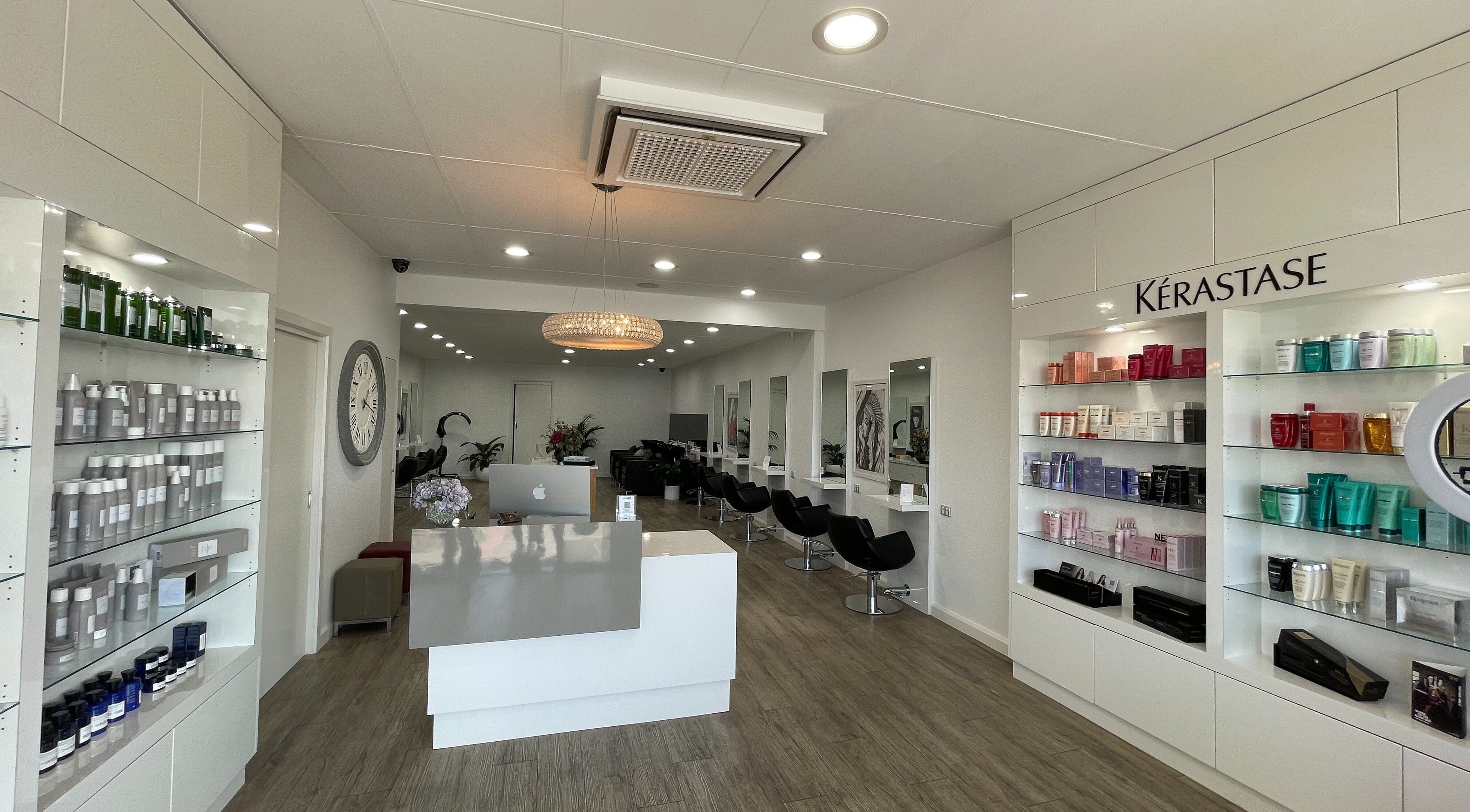 Elegant interior of Studio 51 Hair Design in Melbourne, Victoria, AU, featuring sleek salon chairs and product displays.