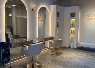 Modern interior of Alma Beauty Salon in Lusail, Al Daayen Municipality, QA with stylish mirrors and seating.