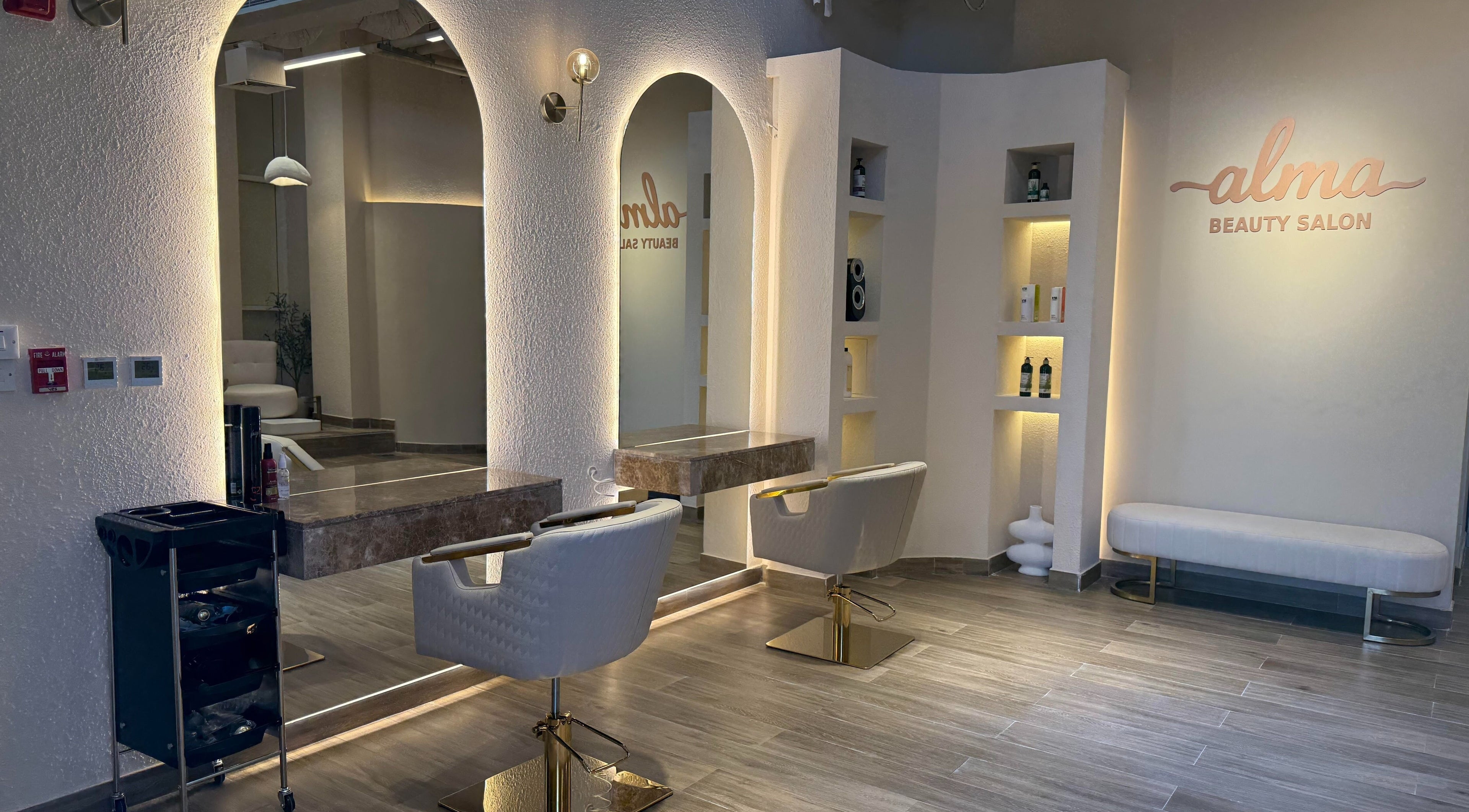Modern interior of Alma Beauty Salon in Lusail, Al Daayen Municipality, QA with stylish mirrors and seating.