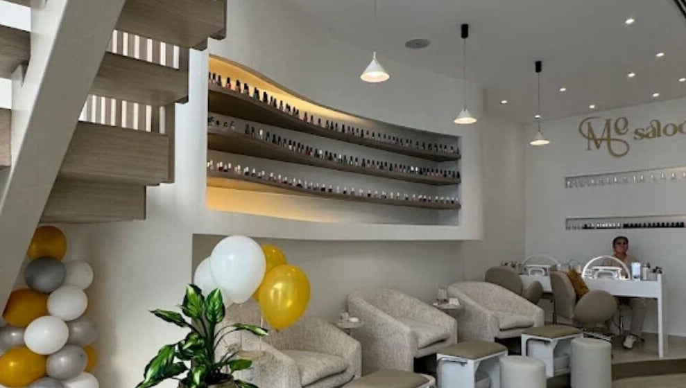 Modern interior of Me Salon in Riyadh, Riyadh Province, SA, featuring stylish seating and nail polish display.