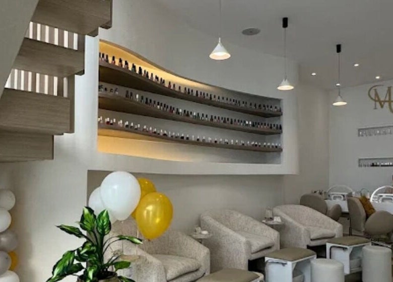 Modern interior of Me Salon in Riyadh, Riyadh Province, SA, featuring stylish seating and nail polish display.
