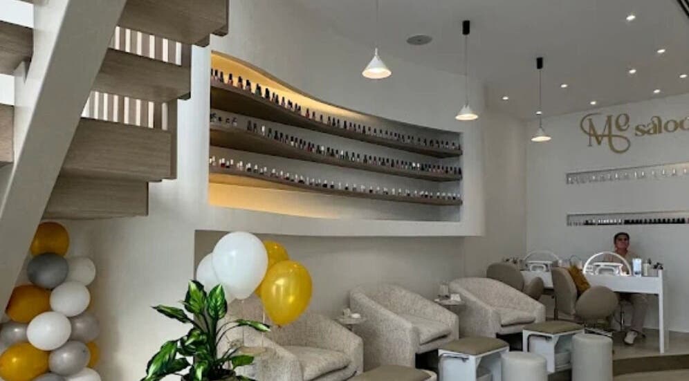 Modern interior of Me Salon in Riyadh, Riyadh Province, SA, featuring stylish seating and nail polish display.