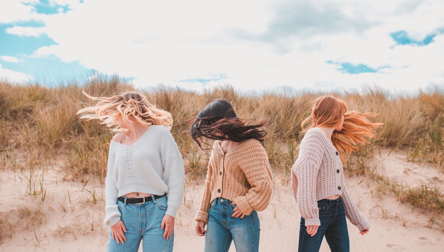 Models display trendy hairstyles on a breezy beach, styled by Emma Combe Hair in North Berwick, Scotland, GB.
