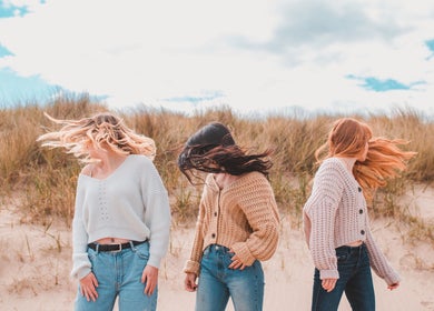Models display trendy hairstyles on a breezy beach, styled by Emma Combe Hair in North Berwick, Scotland, GB.