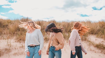 Models display trendy hairstyles on a breezy beach, styled by Emma Combe Hair in North Berwick, Scotland, GB.