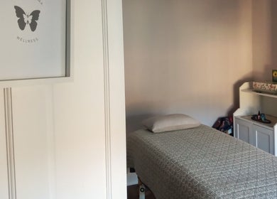 Relaxing massage room at Little Mamma Wellness, Bowburn, England featuring serene decor and treatment bed.