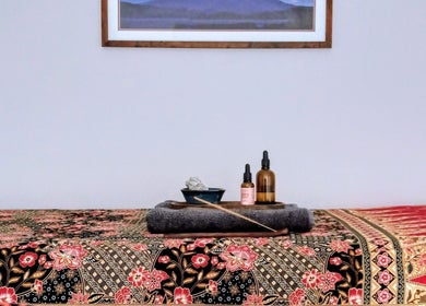 Relaxing wellness setup at Little Mamma Wellness, Bowburn, England features oils on a floral-patterned table.