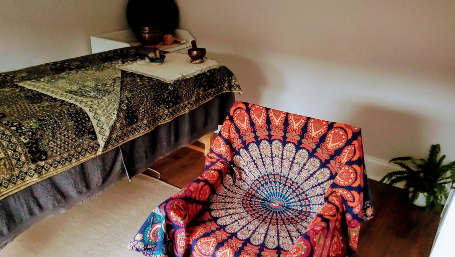 Elegant massage room at Little Mamma Wellness in Bowburn, England featuring vibrant decor and calming ambiance.