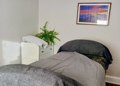 Relaxing treatment room at Little Mamma Wellness in Bowburn, England, GB, featuring cozy bed and soothing decor.