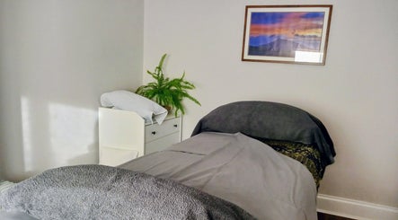 Relaxing treatment room at Little Mamma Wellness in Bowburn, England, GB, featuring cozy bed and soothing decor.