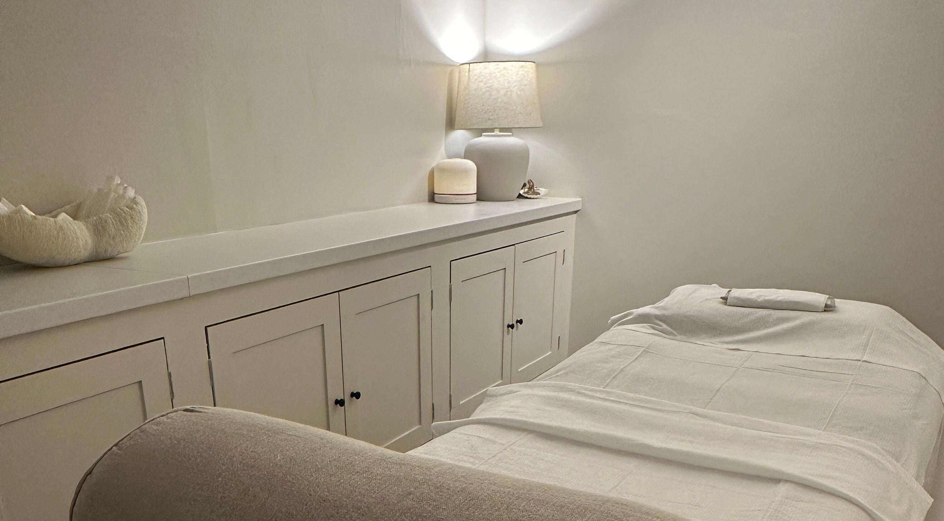 Relaxing spa room at Beauty by Ella, Derby, England, GB, with a cozy massage bed and ambient lighting.