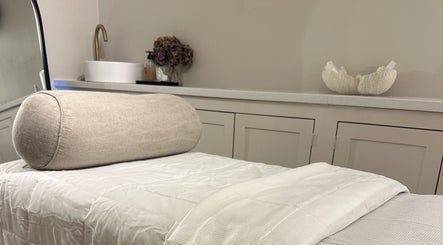 Relaxing treatment room at Beauty by Ella, Derby, England, GB with plush towel and soft lighting.