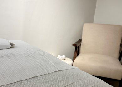 Cozy therapy room at Beauty by Ella, Derby, England, GB offers a tranquil atmosphere with plush seating and soft linens.