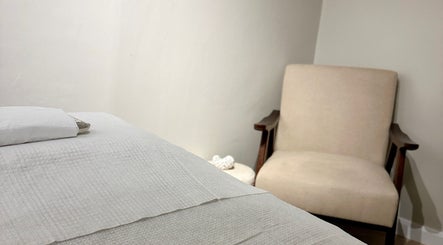 Cozy therapy room at Beauty by Ella, Derby, England, GB offers a tranquil atmosphere with plush seating and soft linens.