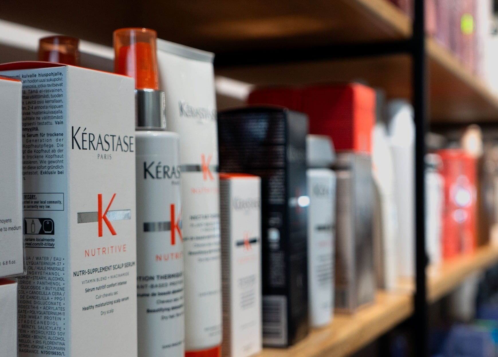 Haircare products displayed on wooden shelves at Le Salon Sugar (Rosemère), Rosemère, Québec, CA.