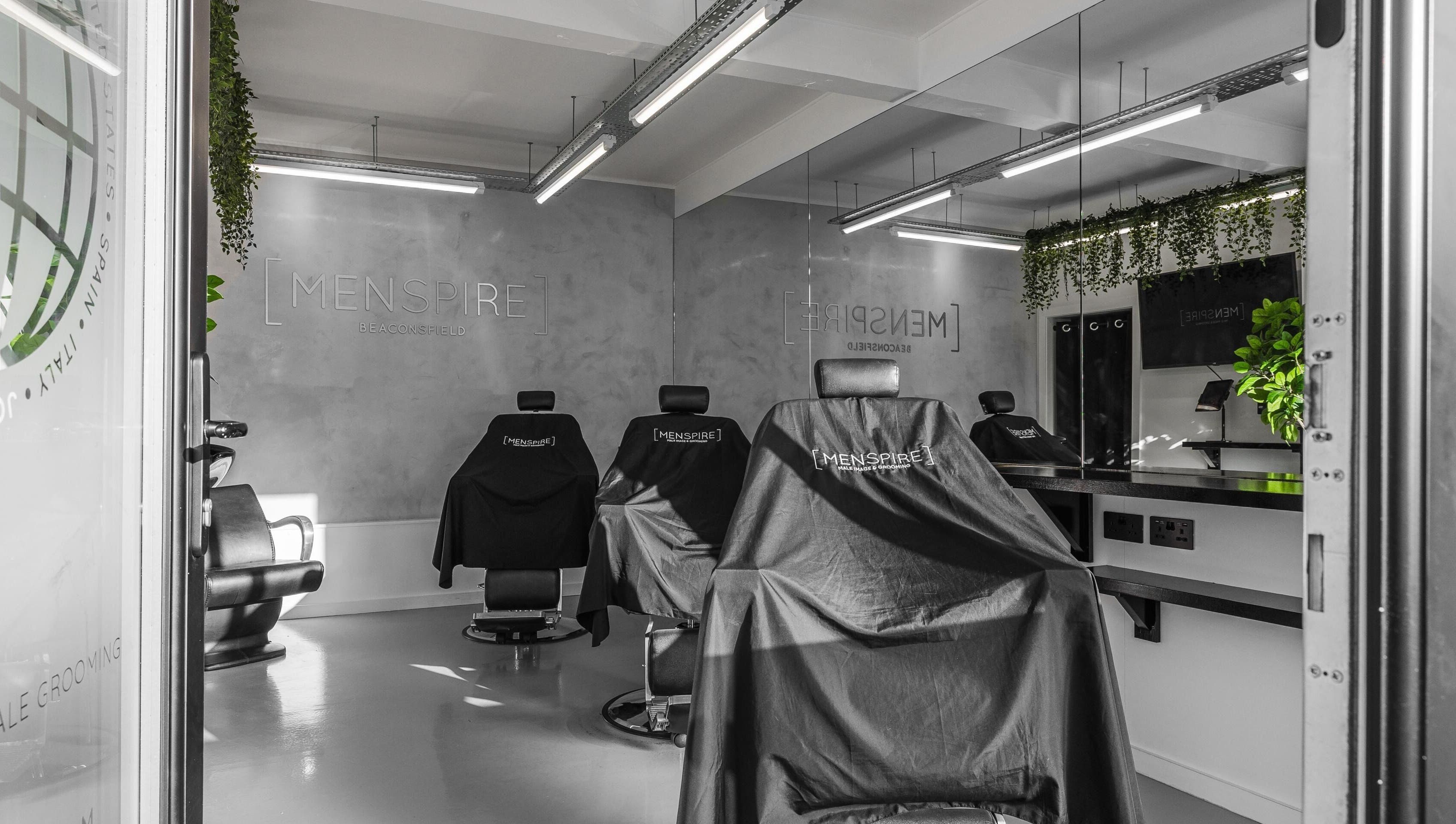 Modern interior of Menspire Beaconsfield, showcasing barber chairs and sleek decor in Beaconsfield, England, GB.