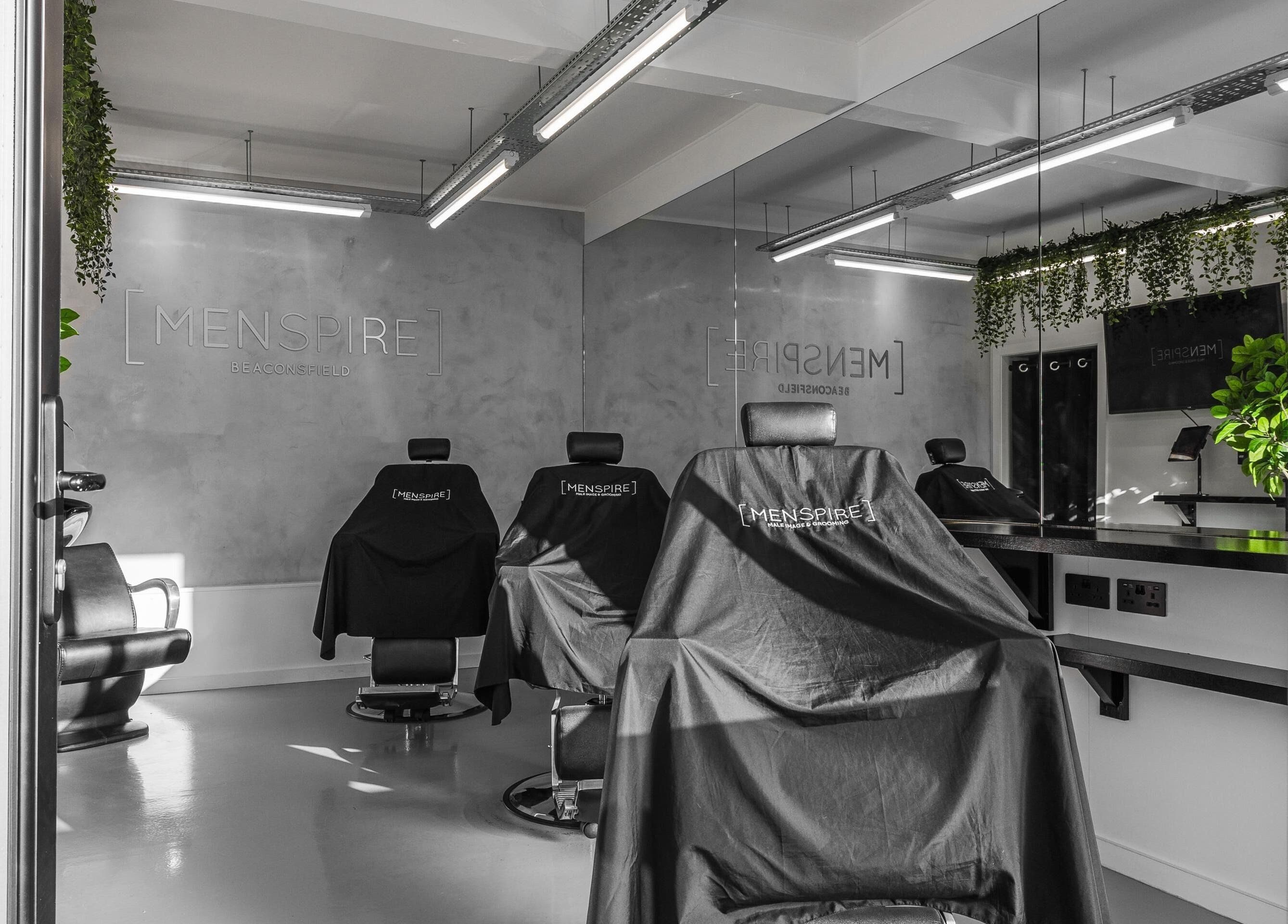 Modern interior of Menspire Beaconsfield, showcasing barber chairs and sleek decor in Beaconsfield, England, GB.