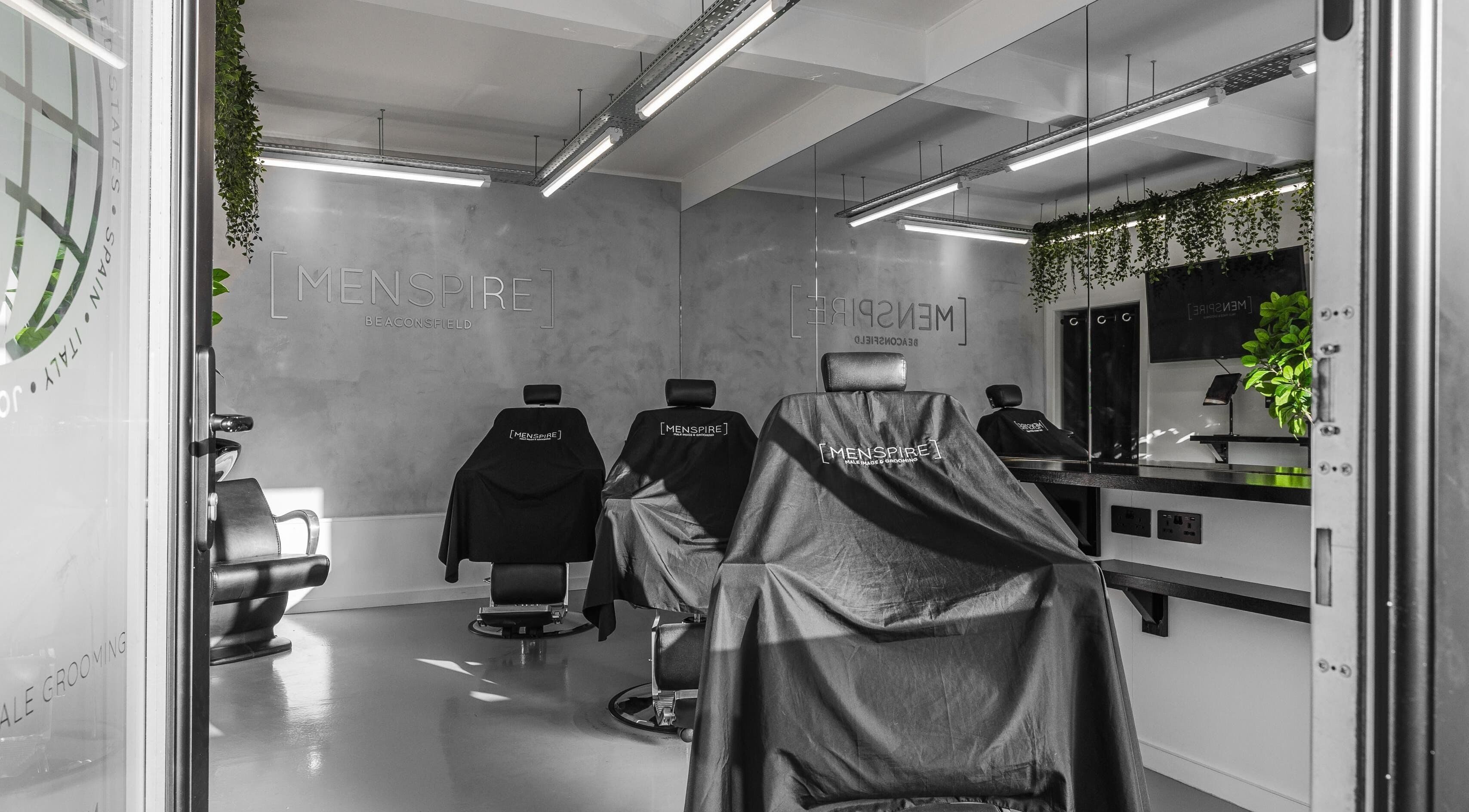 Modern interior of Menspire Beaconsfield, showcasing barber chairs and sleek decor in Beaconsfield, England, GB.
