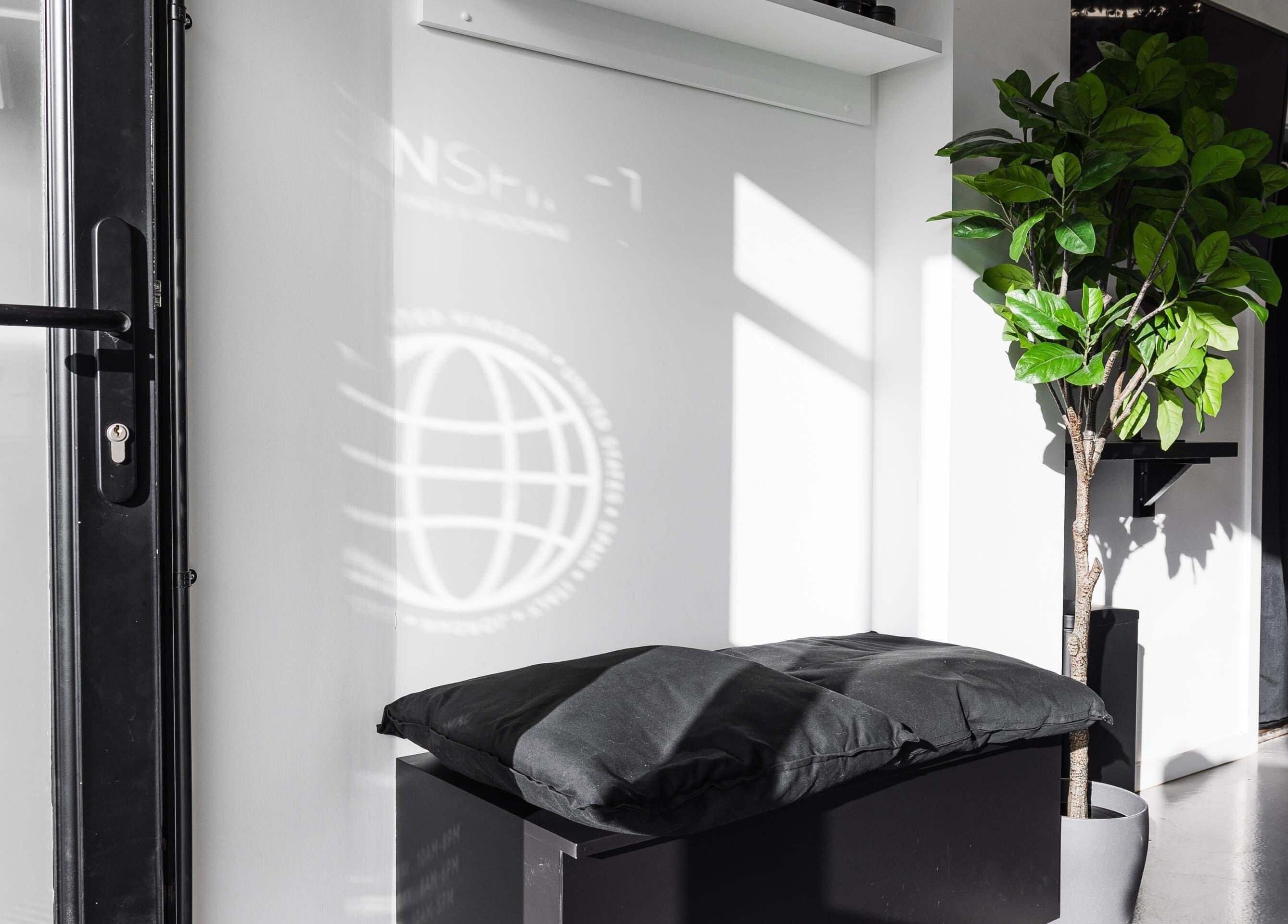 Modern entryway with plant and seating at Menspire Beaconsfield, Beaconsfield, England, GB.