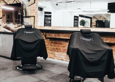 Interior of Menspire St Albans salon, featuring stylish barber chairs. Located in St Albans, England, GB.