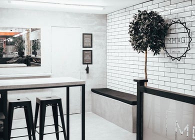 Modern interior of Menspire St Albans in St Albans, England, GB with stylish seating and white brick walls.