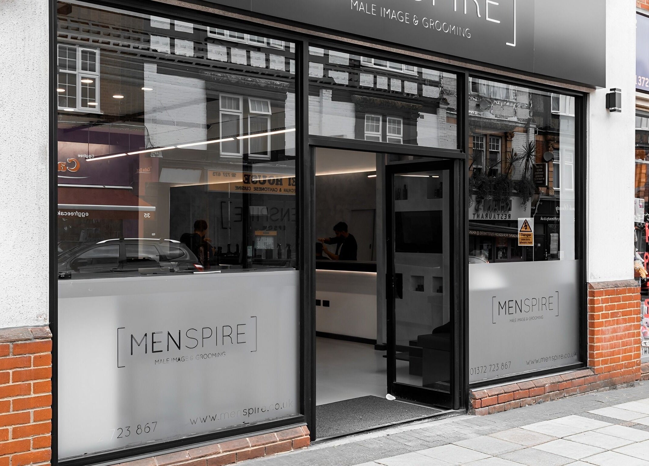 Entrance of Menspire Epsom, a grooming venue in Epsom, England, GB, with modern design.