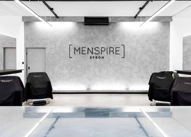 Modern interior of Menspire Epsom salon in Epsom, England, GB showcasing sleek design and barber chairs.
