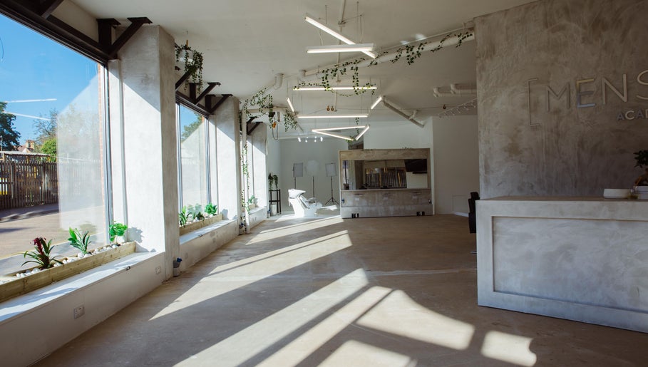 Spacious, modern interior of Menspire Academy in St Albans, England, GB with natural light and sleek decor.