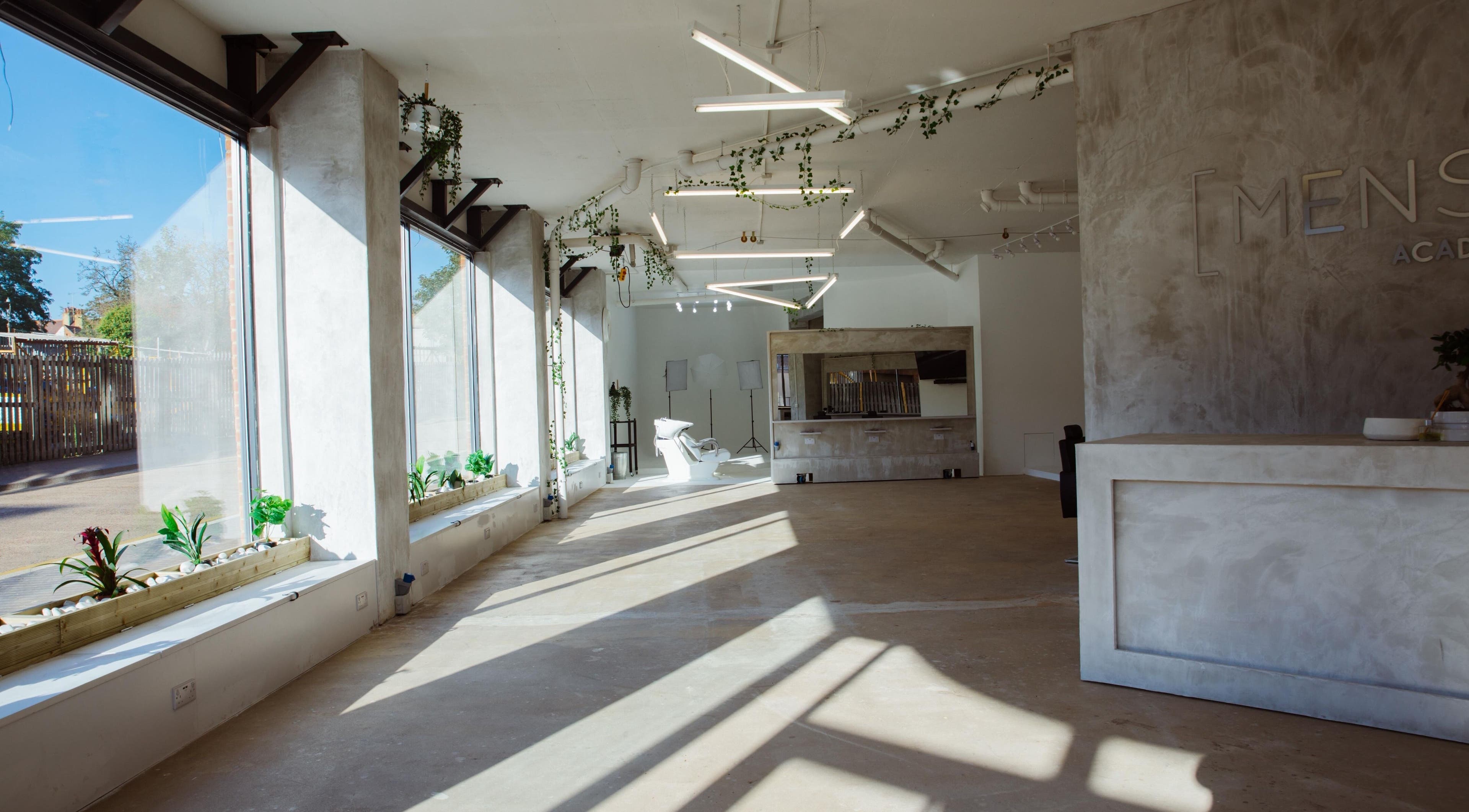 Spacious, modern interior of Menspire Academy in St Albans, England, GB with natural light and sleek decor.