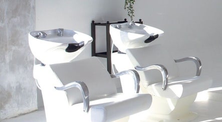 Modern hair washing chairs at Menspire Academy, St Albans, England, GB for luxurious salon experience.
