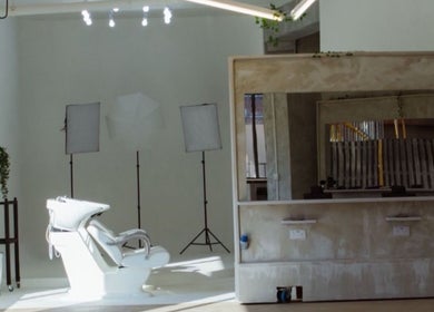 Sleek salon interior at Menspire Academy, St Albans, England, GB showcasing minimalist design and styling chairs.