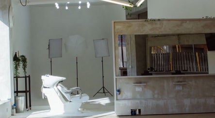 Sleek salon interior at Menspire Academy, St Albans, England, GB showcasing minimalist design and styling chairs.