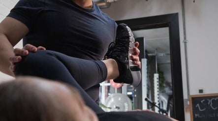 Physical therapist assisting a stretch at A Fitness - Health and Wellness Clinic, London, England, GB.