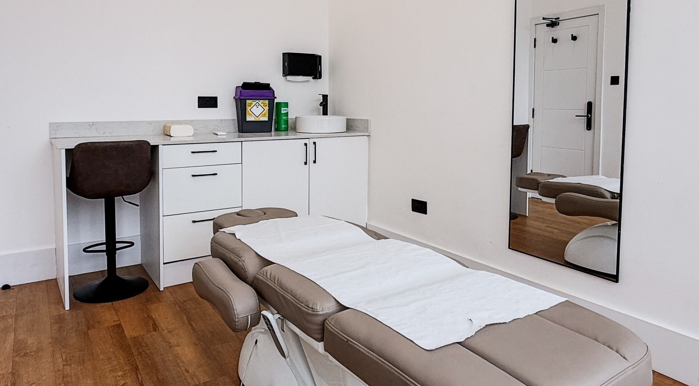 Sleek therapy room at A Fitness - Physical Therapy Clinic, London, England, GB, featuring a treatment bed.