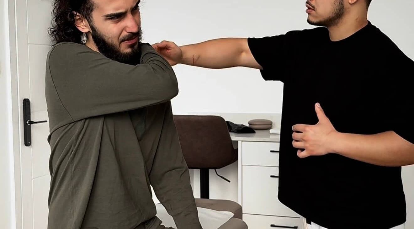 A therapist assists a client with shoulder exercises at A Fitness - Physical Therapy Clinic, London, England, GB.