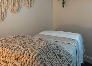 Tranquil therapy room at Radiance by Rylie, Boiling Springs, South Carolina, US, with soft blankets and wall decor.