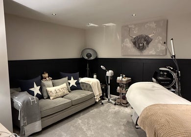 Inviting spa room at SKinGlow.Co, Ripon, England, GB, with cozy sofa and treatment equipment.