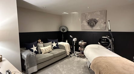 Inviting spa room at SKinGlow.Co, Ripon, England, GB, with cozy sofa and treatment equipment.