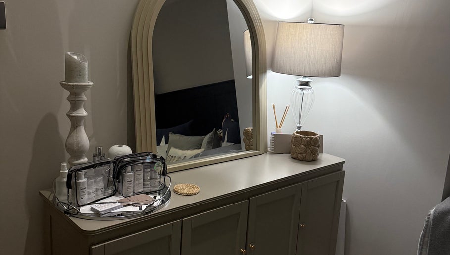 Elegant dresser with mirror and beauty products at SKinGlow.Co, Ripon, England, GB.