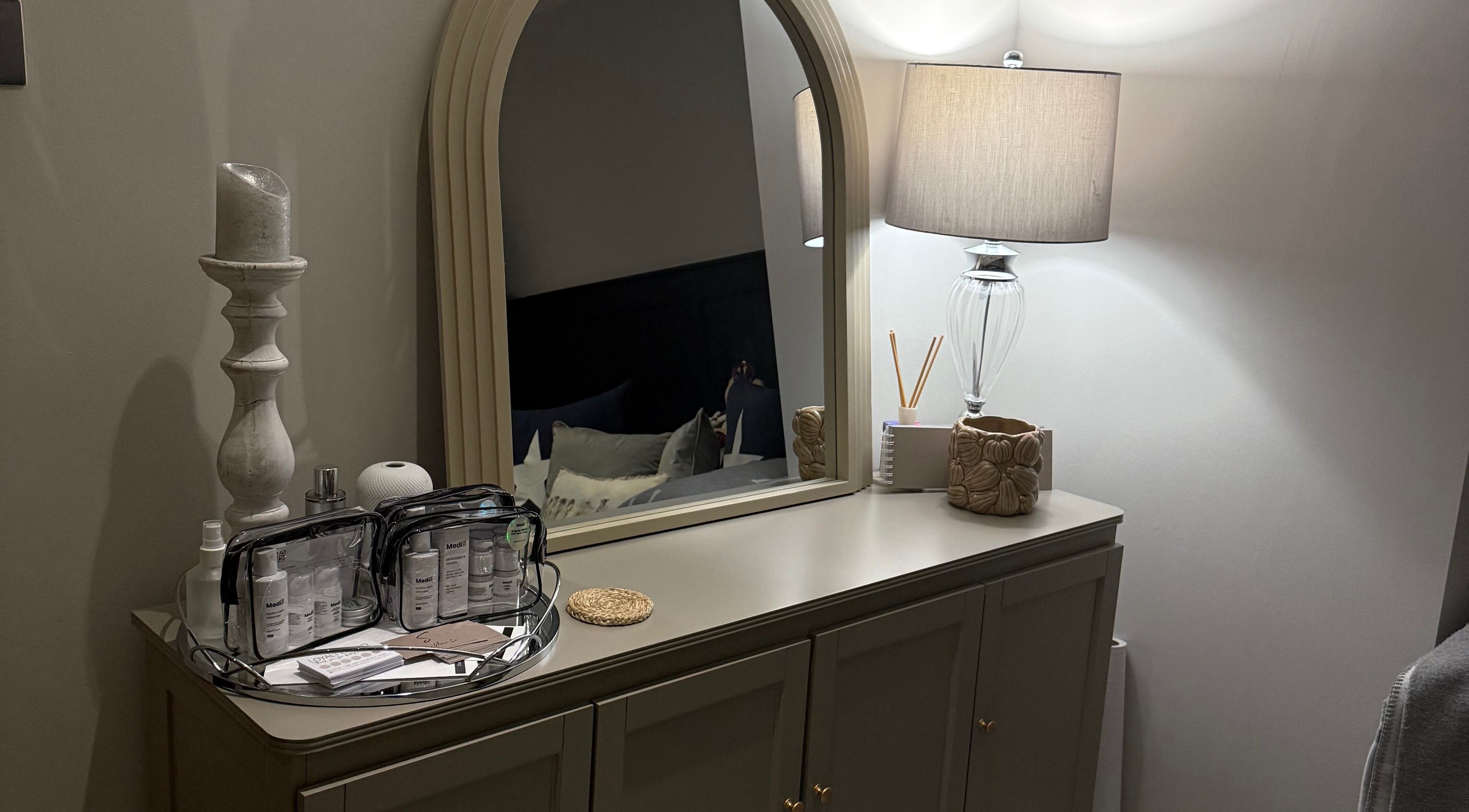 Elegant dresser with mirror and beauty products at SKinGlow.Co, Ripon, England, GB.