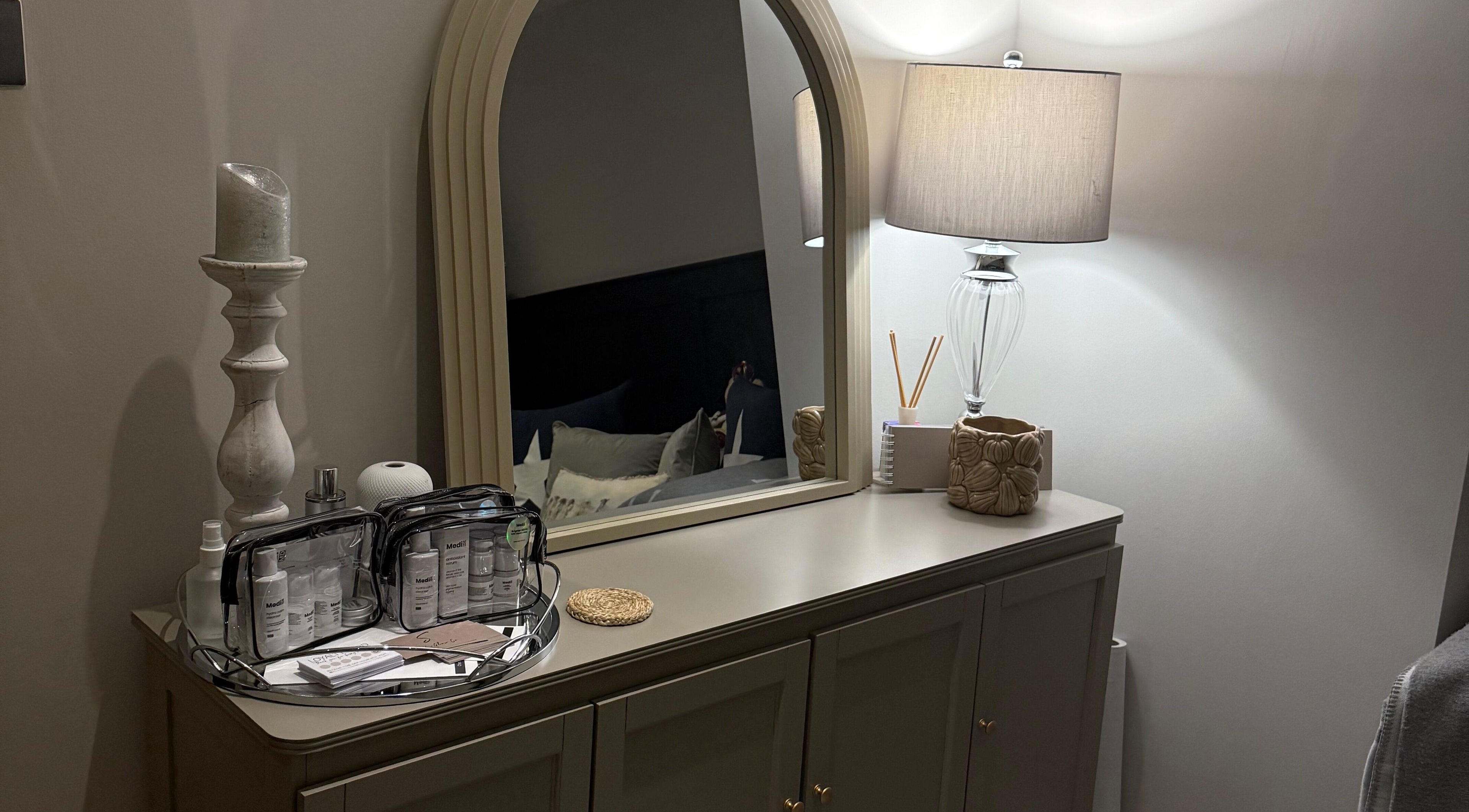 Elegant dresser with mirror and beauty products at SKinGlow.Co, Ripon, England, GB.