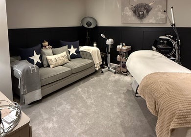 Relaxing treatment room at SKinGlow.Co, Ripon, England, GB with plush couch and massage table.
