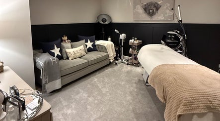 Relaxing treatment room at SKinGlow.Co, Ripon, England, GB with plush couch and massage table.