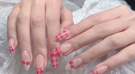 Stylish cherry and check nail art by Woo Salon Studio in Arcadia, California, US.