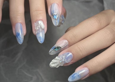 Intricate nail design with blue and silver accents at Woo Salon Studio, Arcadia, California, US.