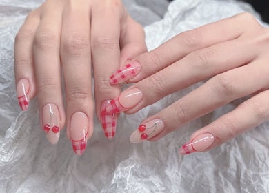 Stylish cherry-themed nail art at Woo Salon Studio in Arcadia, California, US.