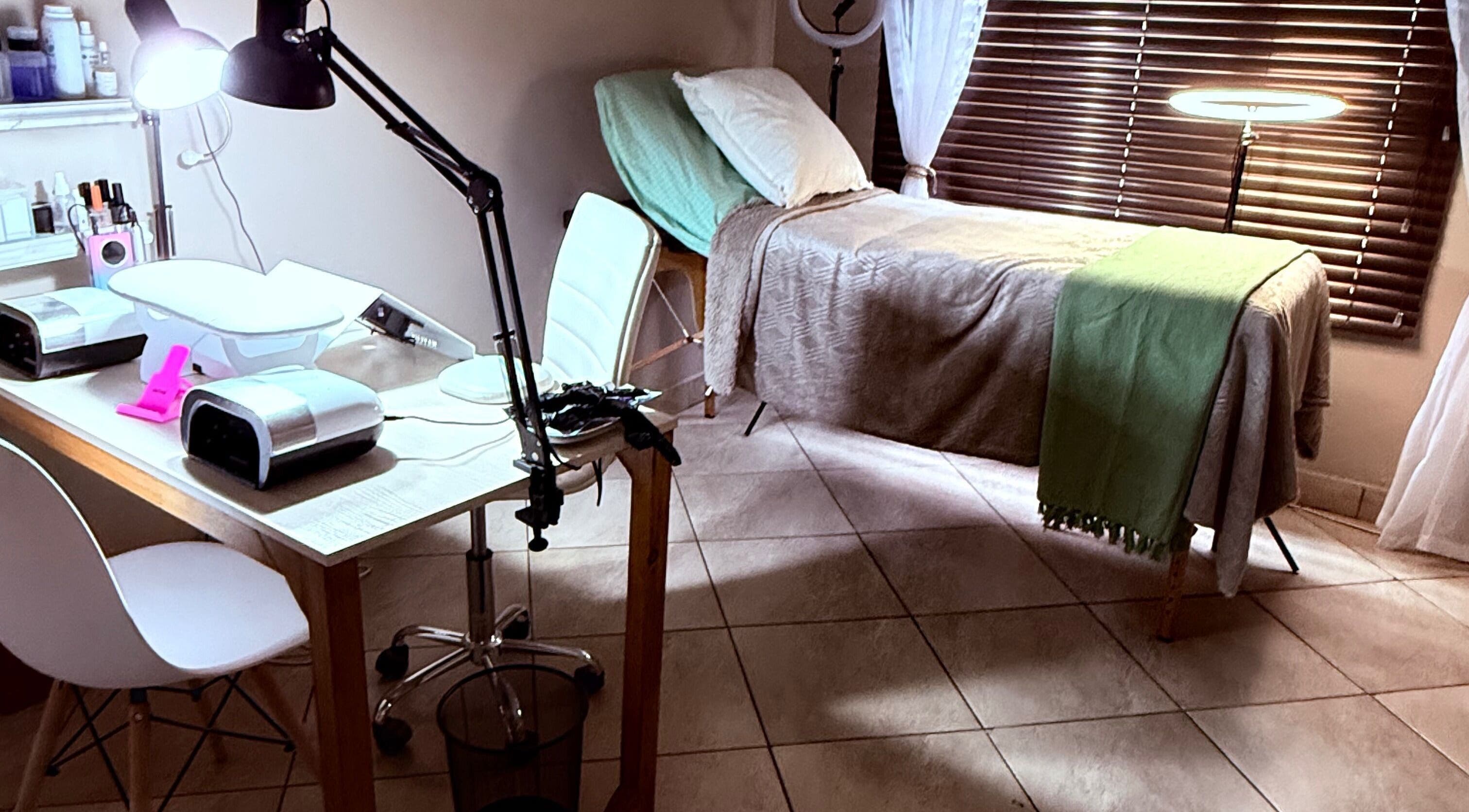 Relaxing treatment room at Celeste Lindsay Artistry, Rustenburg, North West, ZA with bed and work desk.