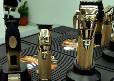 Golden clippers at Dream Fade Gents Salon, Dubai, Dubai, AE, showcasing premium grooming tools.